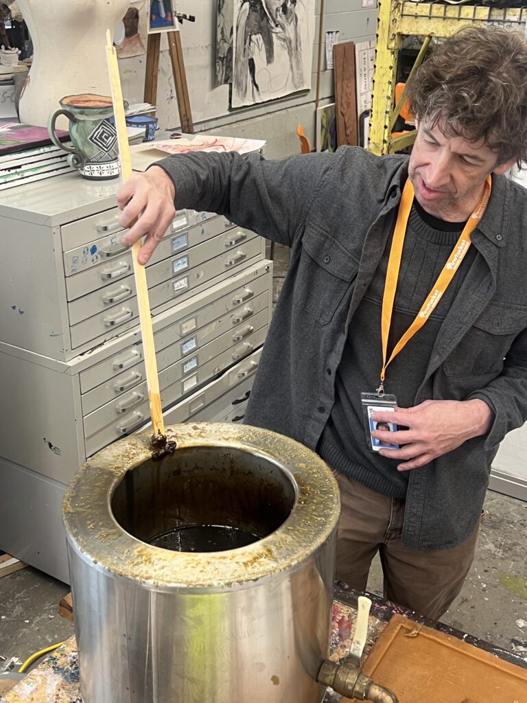 Instructor Chris Kane demonstrates bronze casting at the "Make Your Own Cast in Bronze Belt Buckle" workshop.