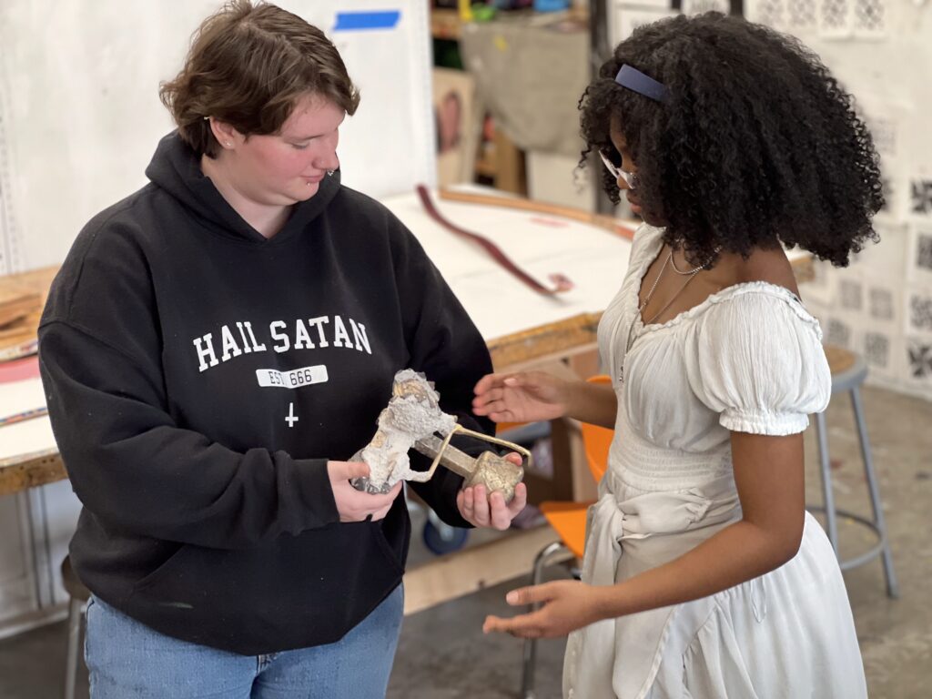 Two students collaborate during a belt buckle workshop.